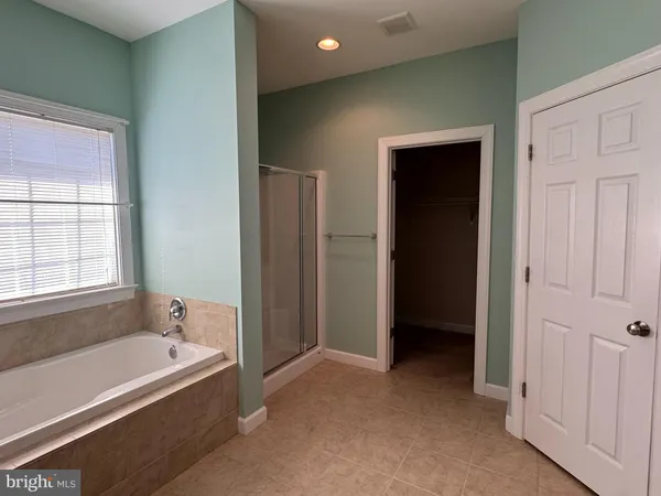 a bathroom with bathtub and a shower
