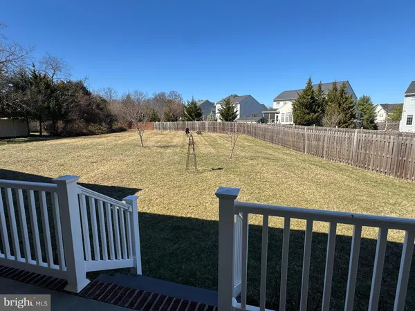a view of a balcony with floor to ceiling window and wooden fence