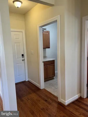 a view of a hallway with wooden floor
