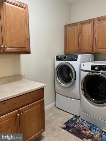 a utility room with sink dryer and washer