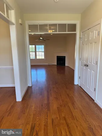 a view of empty room with wooden floor and fireplace
