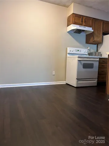 a stove top oven sitting inside of a kitchen