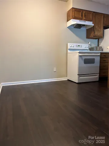 a view of a kitchen with wooden floor