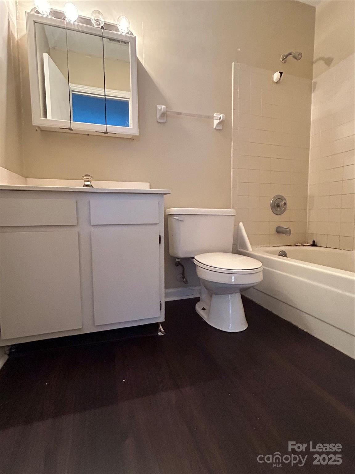 9629 Vinca Circle, Unit H Charlotte, NC 28213 - Photo 9 of 10 a bathroom with a toilet a sink and mirror