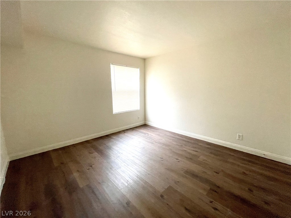 3135 South Mojave Road, Unit 221 Las Vegas, NV 89121 - Photo 15 of 19 A well-lit room featuring rich wood flooring and a single window.