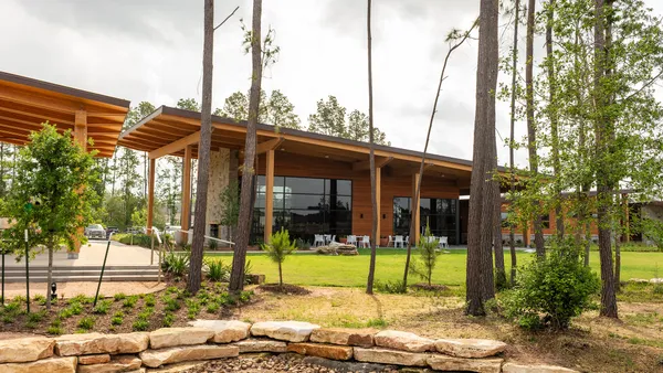 a view of a patio with table and chairs and wooden fence