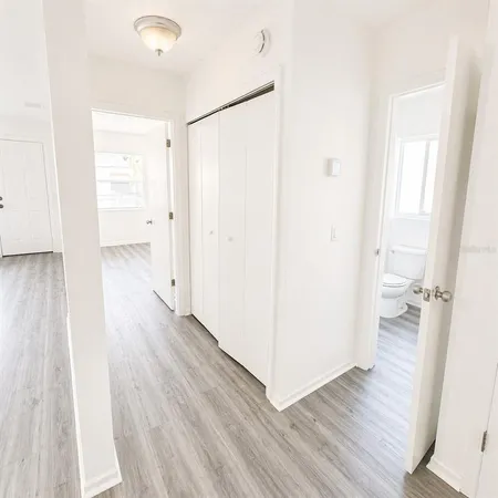a bathroom with a toilet sink a mirror and vanity