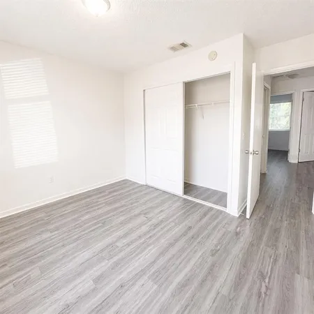 a view of a room with wooden floor