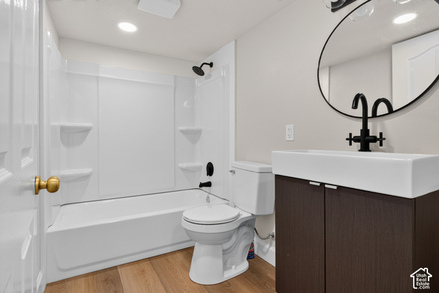 147 Center Street Clearfield, UT 84015 - Photo 38 of 55 Tub-shower combination with matte black fixtures, wood-finish flooring, dark wood-finish vanity with white rectangular vessel sink, and a circular wall-mounted mirror