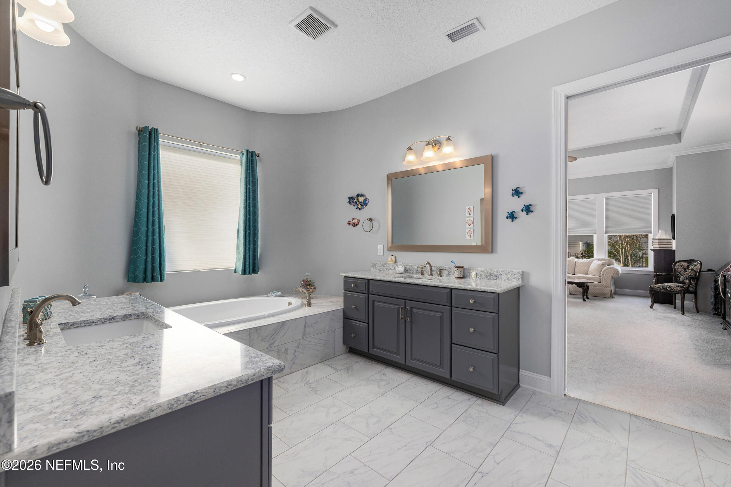 220 Honey Blossom Road St. Johns, FL 32259 - Photo 39 of 99 a bathroom with a granite countertop sink a mirror and a bathtub