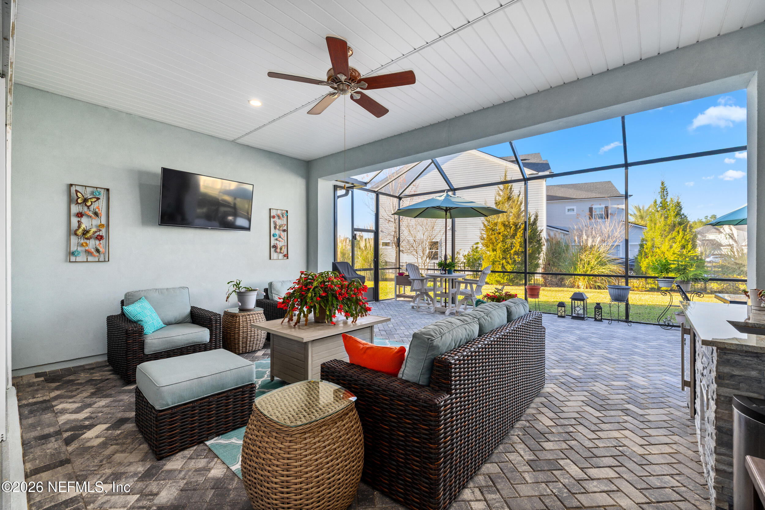 220 Honey Blossom Road St. Johns, FL 32259 - Photo 7 of 99 a living room with furniture a flat screen tv and a large window