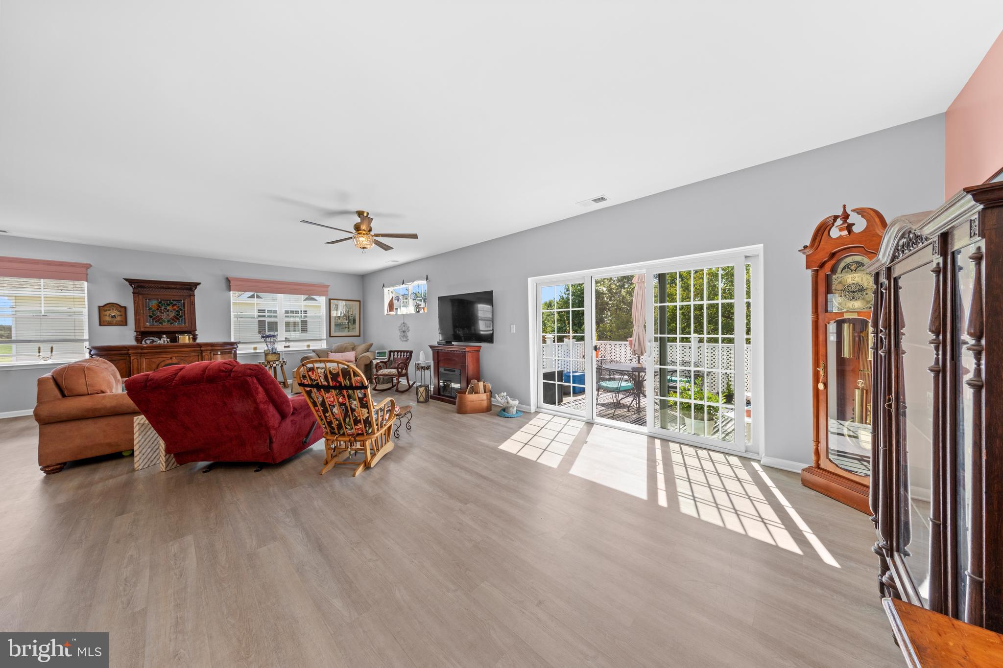 24525 Merlot Drive Lewes, DE 19958 - Photo 12 of 40 a living room with furniture floor to ceiling window and wooden floor