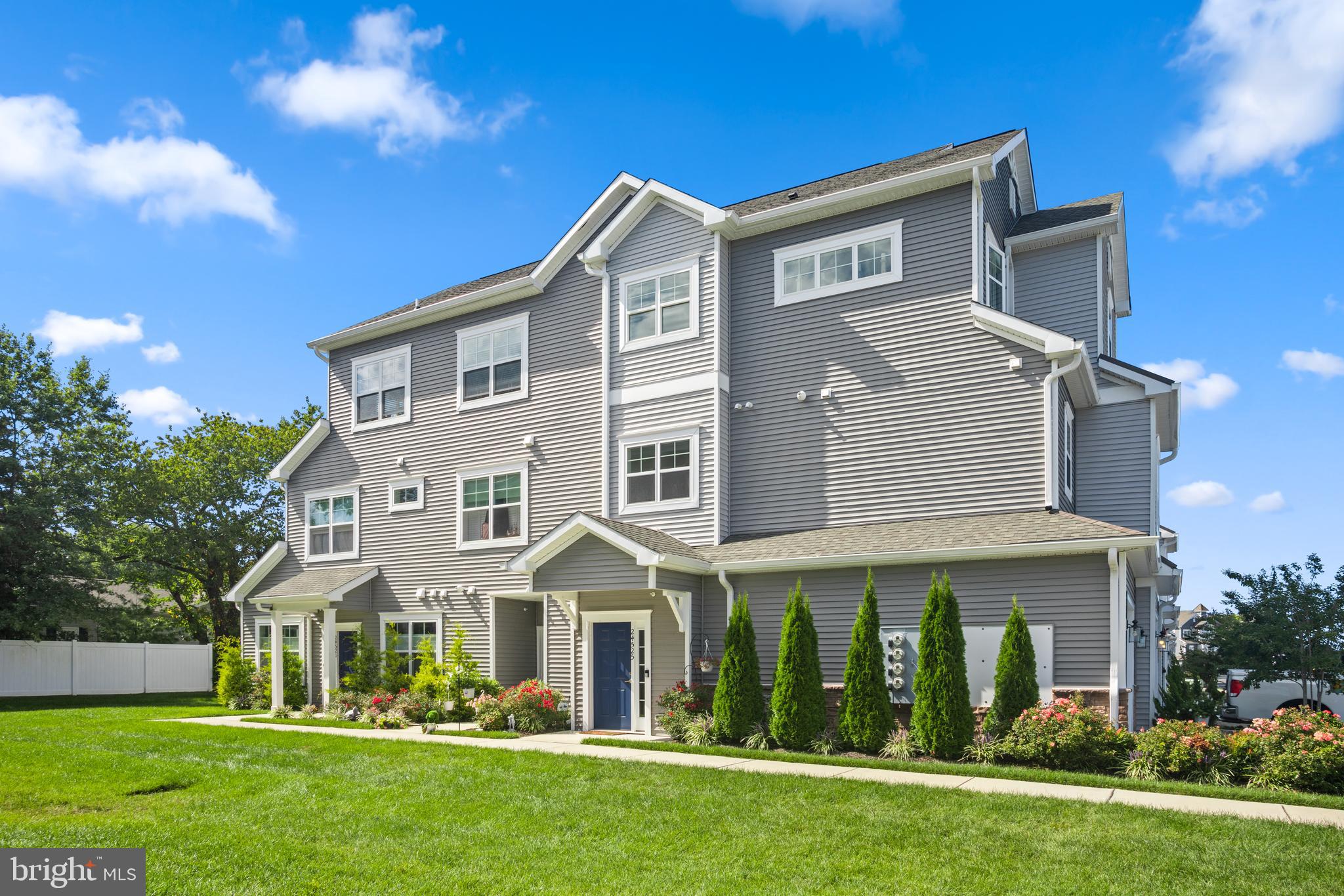 24525 Merlot Drive Lewes, DE 19958 - Photo 2 of 40 a front view of a house with a garden