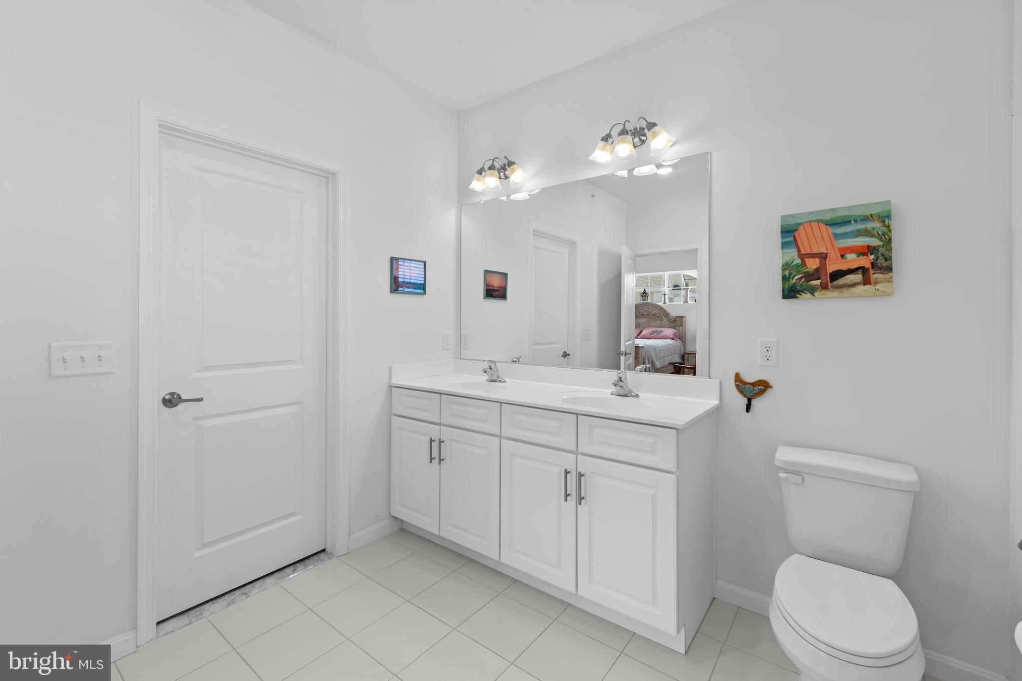 24525 Merlot Drive Lewes, DE 19958 - Photo 30 of 40 a view of bathroom with a toilet sink mirror and vanity
