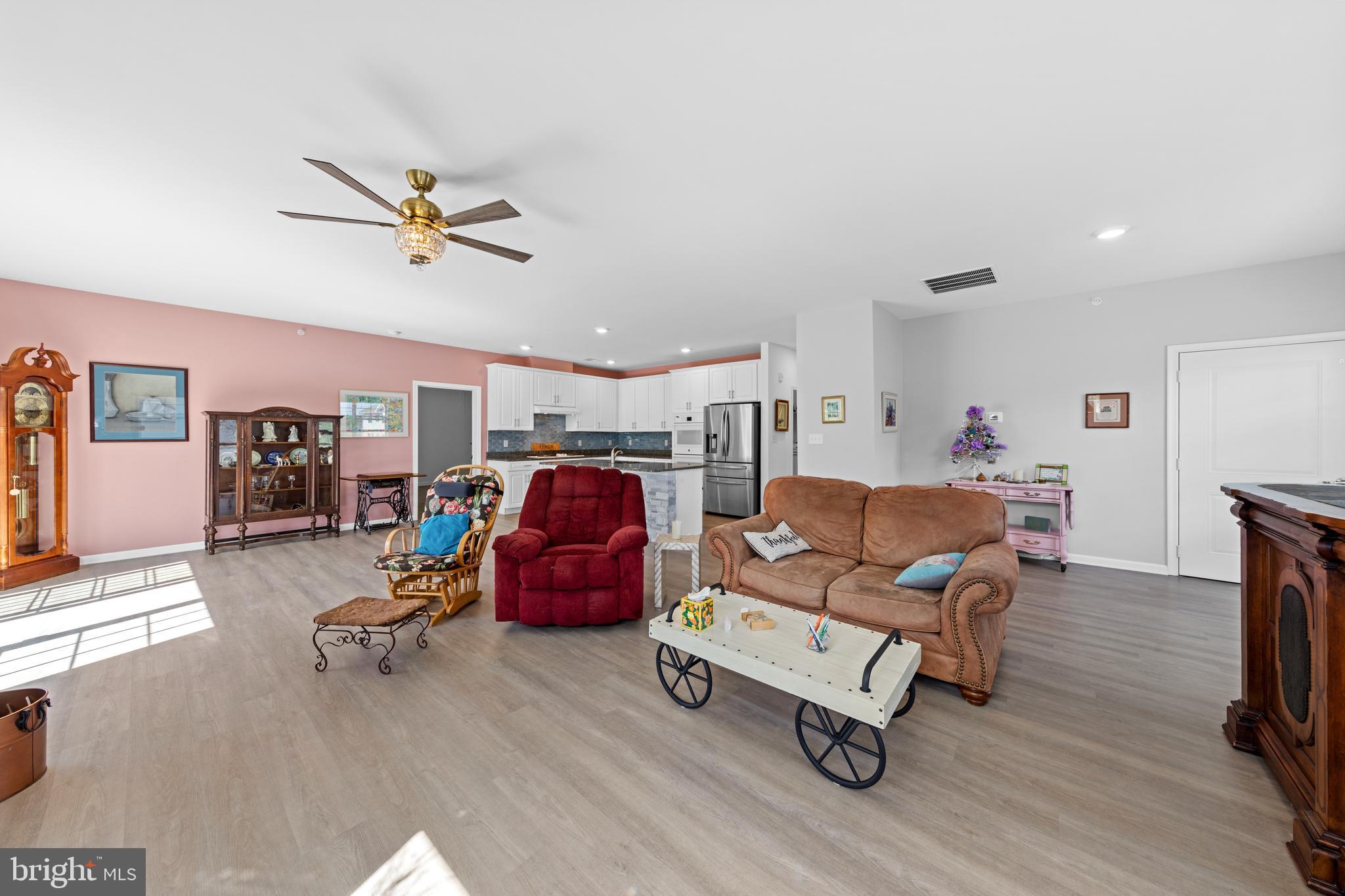 24525 Merlot Drive Lewes, DE 19958 - Photo 9 of 40 a living room with furniture a flat screen tv and a table