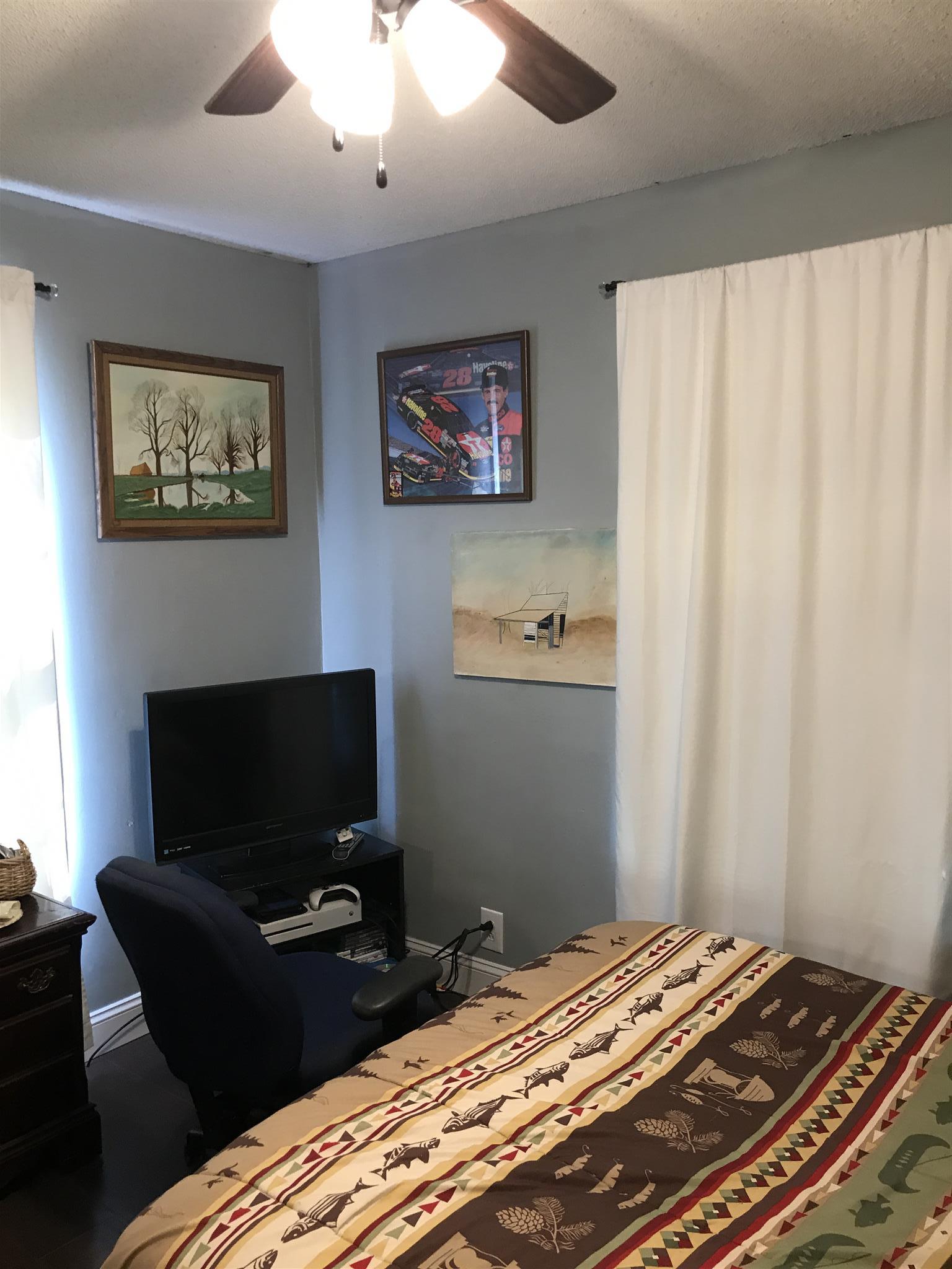 82 Five Points Road Loretto, TN 38469 - Photo 11 of 24 a bedroom with a bed and a television