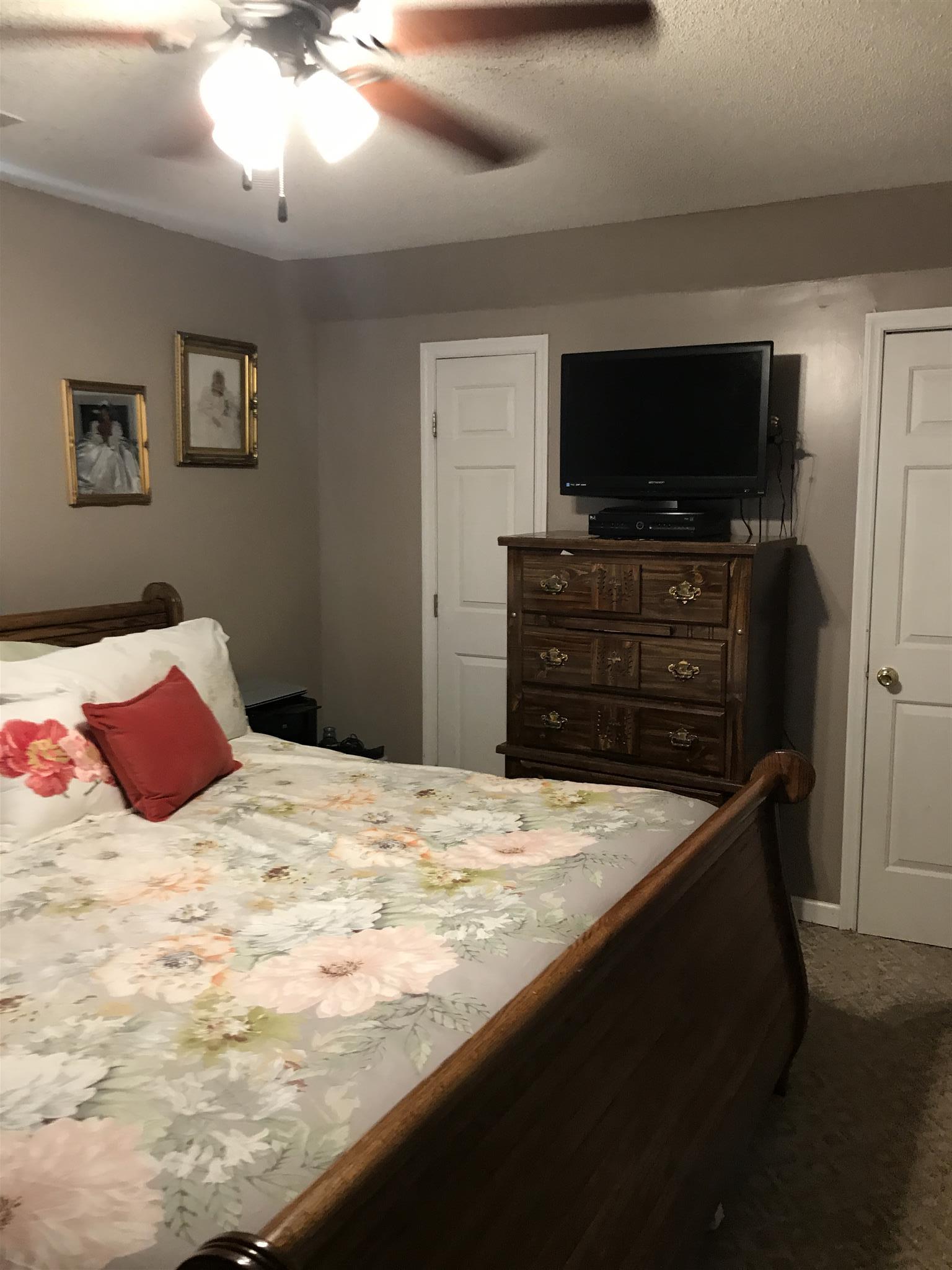 82 Five Points Road Loretto, TN 38469 - Photo 13 of 24 a bedroom with a bed and a flat screen tv