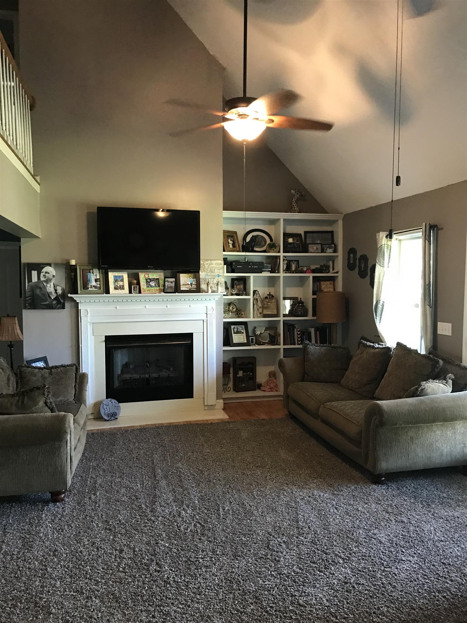 82 Five Points Road Loretto, TN 38469 - Photo 3 of 24 a living room with furniture a flat screen tv and a fireplace