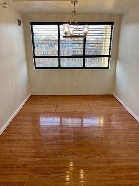 1731 Beacon Street, Unit 512 Brookline, MA 02445 - Photo 18 of 41 a view of a big room with wooden floor and windows