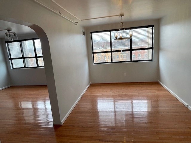 1731 Beacon Street, Unit 512 Brookline, MA 02445 - Photo 19 of 41 wooden floor in an empty room with a window