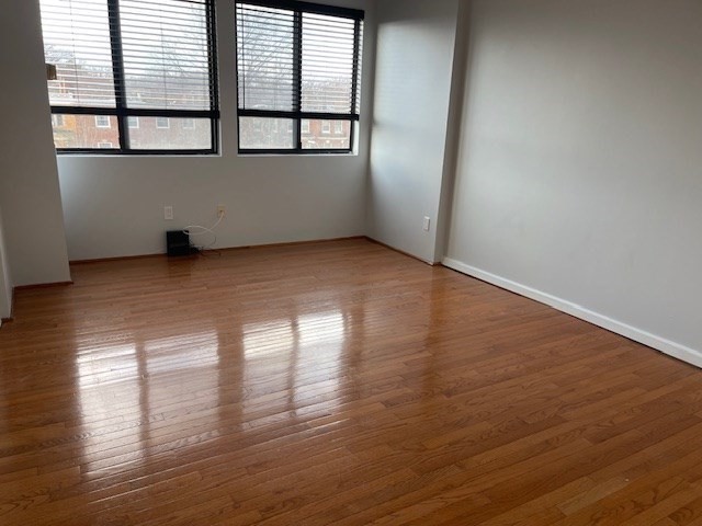 1731 Beacon Street, Unit 512 Brookline, MA 02445 - Photo 20 of 41 a view of empty room with wooden floor and fan