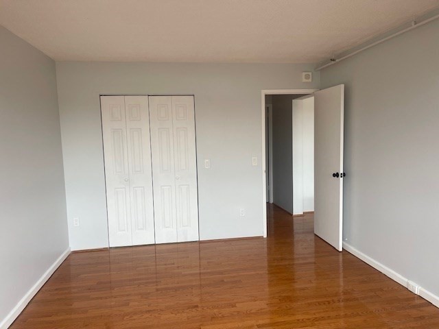 1731 Beacon Street, Unit 512 Brookline, MA 02445 - Photo 21 of 41 a view of an empty room with wooden floor