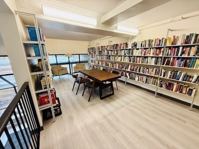 1731 Beacon Street, Unit 512 Brookline, MA 02445 - Photo 29 of 41 a living room with lots of furniture and a book shelf