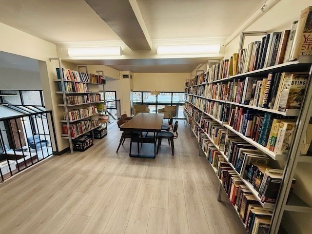 1731 Beacon Street, Unit 512 Brookline, MA 02445 - Photo 30 of 41 a living room with lots of furniture and a book shelf