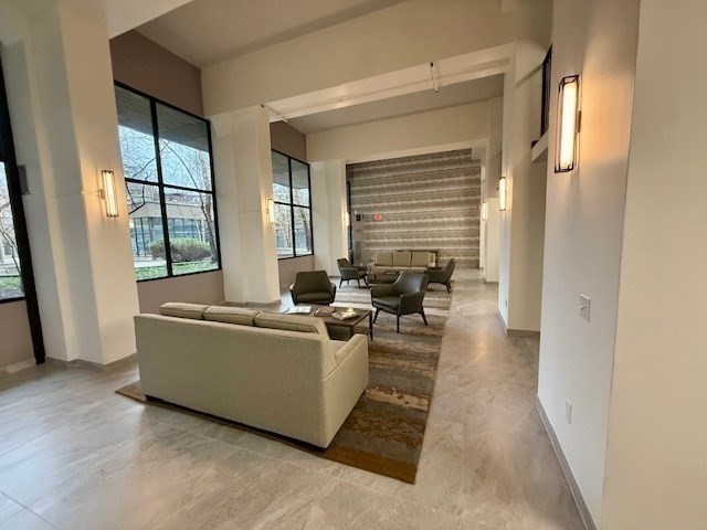1731 Beacon Street, Unit 512 Brookline, MA 02445 - Photo 5 of 41 a living room with furniture and large windows