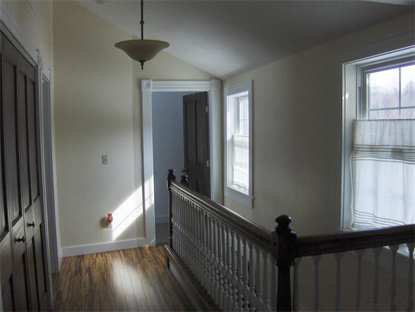84 Warwick Road Northfield, MA 01360 - Photo 22 of 30 a view of a hallway with wooden floor and stairs