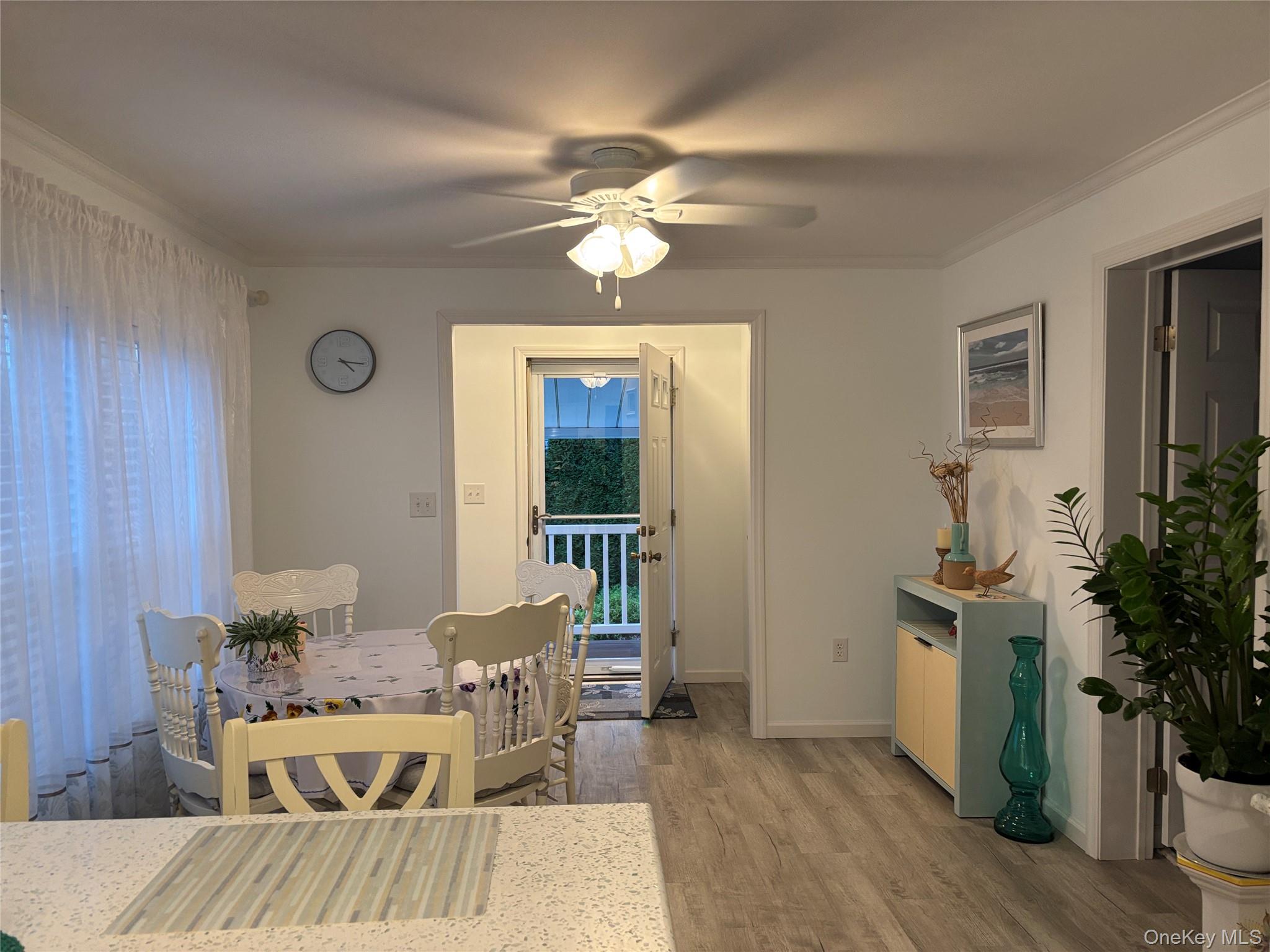 61 Forge Road, Unit 29 Riverhead, NY 11901 - Photo 11 of 38 a living room with furniture and a chandelier
