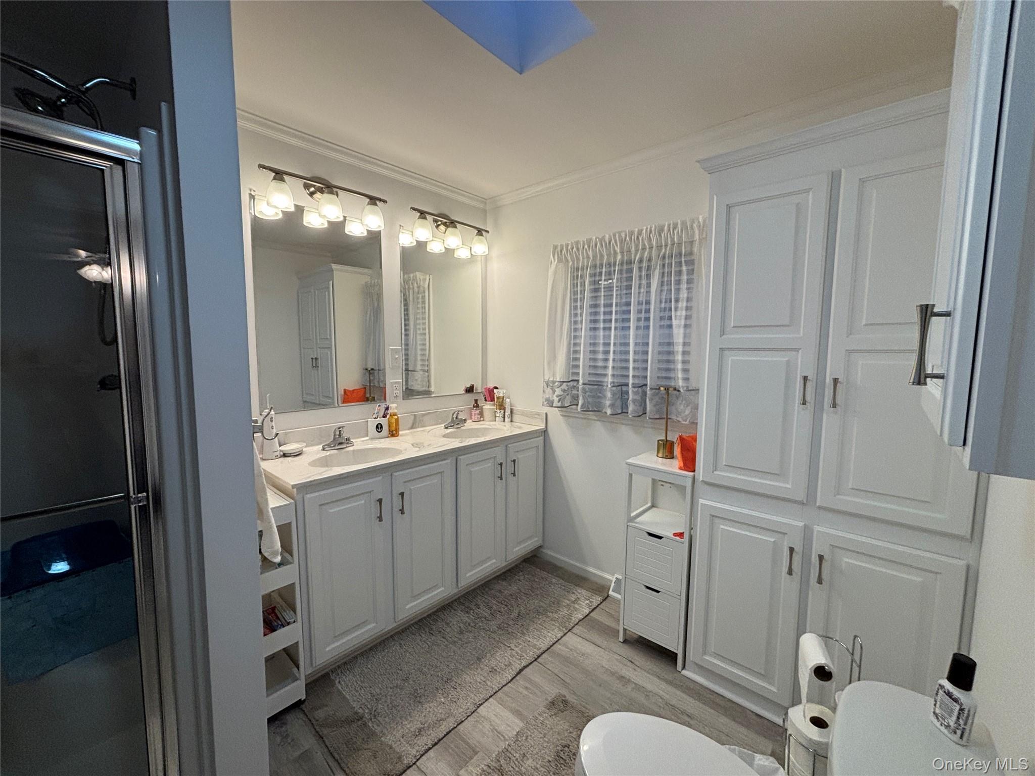 61 Forge Road, Unit 29 Riverhead, NY 11901 - Photo 15 of 38 a bathroom with a double vanity sink toilet and shower
