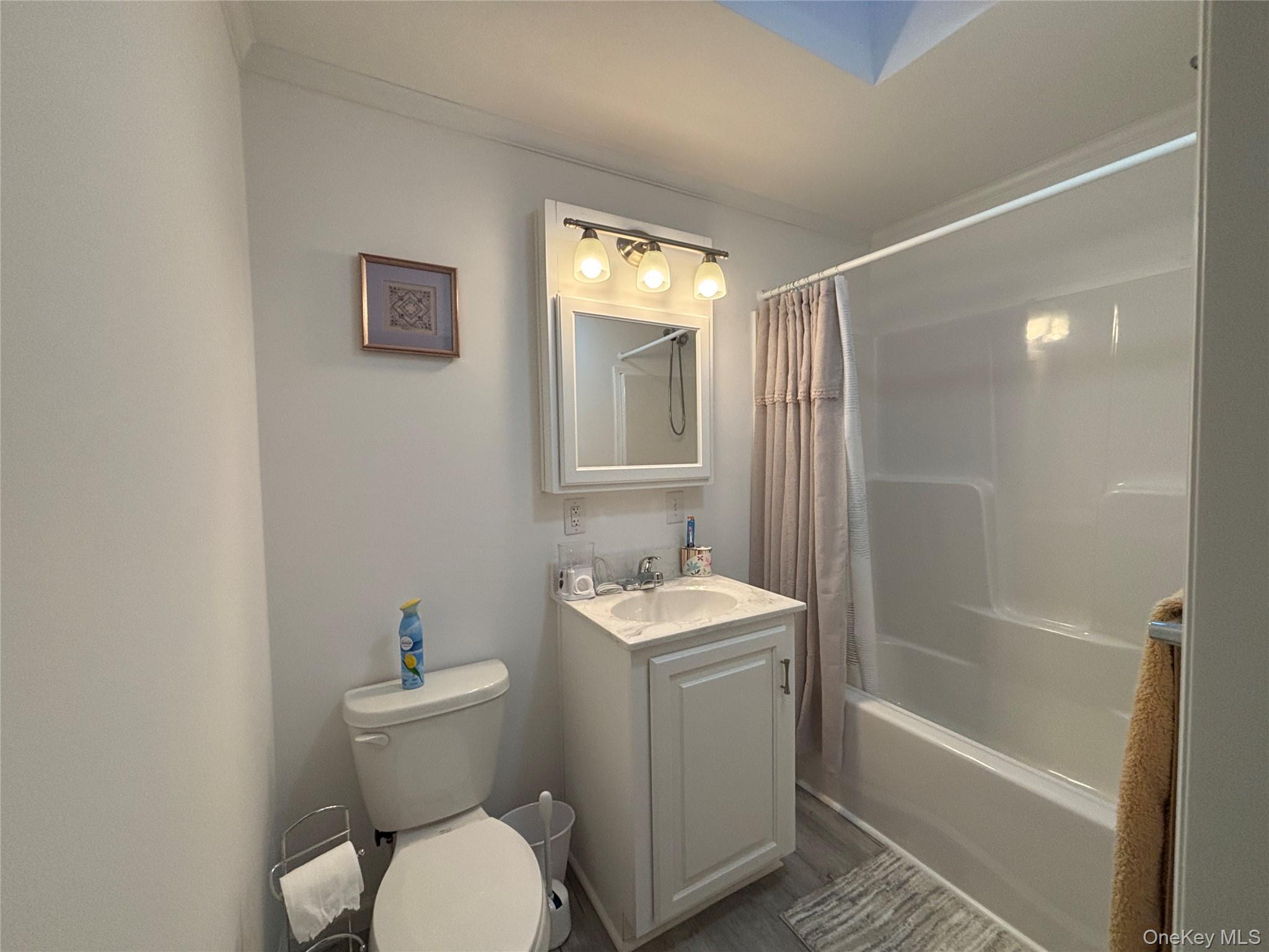 61 Forge Road, Unit 29 Riverhead, NY 11901 - Photo 21 of 38 a bathroom with a sink toilet and shower