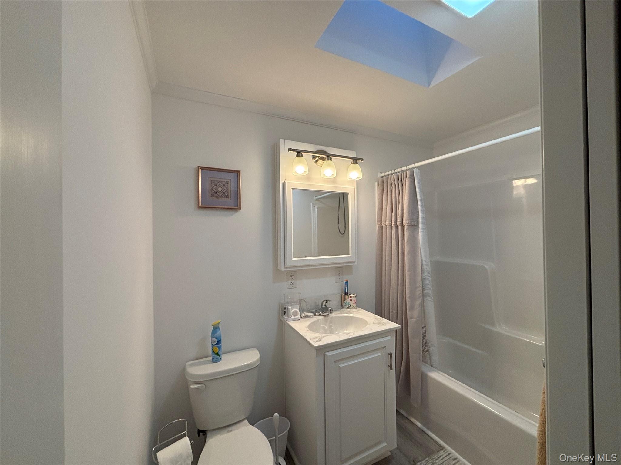 61 Forge Road, Unit 29 Riverhead, NY 11901 - Photo 23 of 38 a bathroom with a sink toilet and shower
