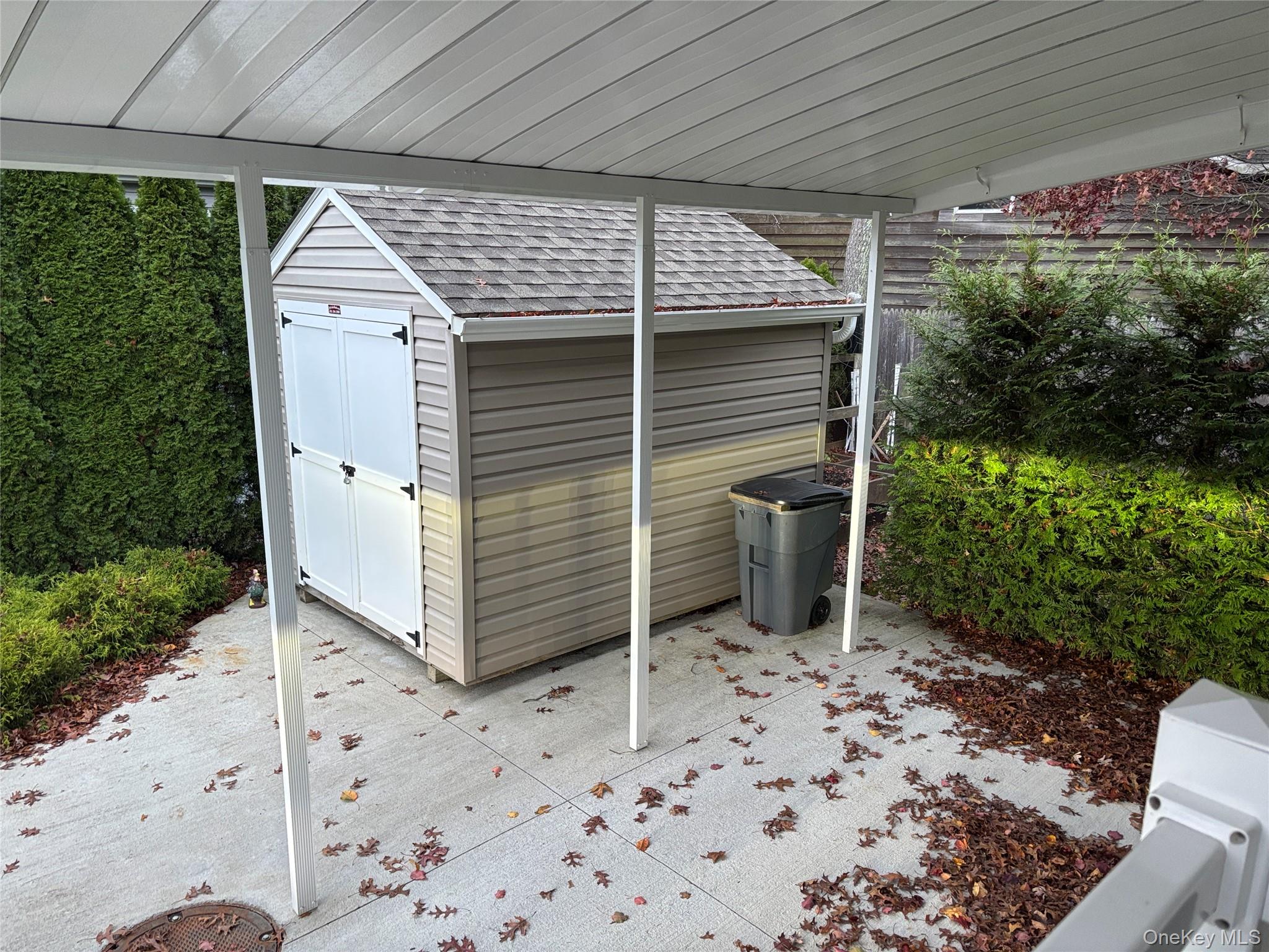 61 Forge Road, Unit 29 Riverhead, NY 11901 - Photo 29 of 38 a view of a porch with a bench