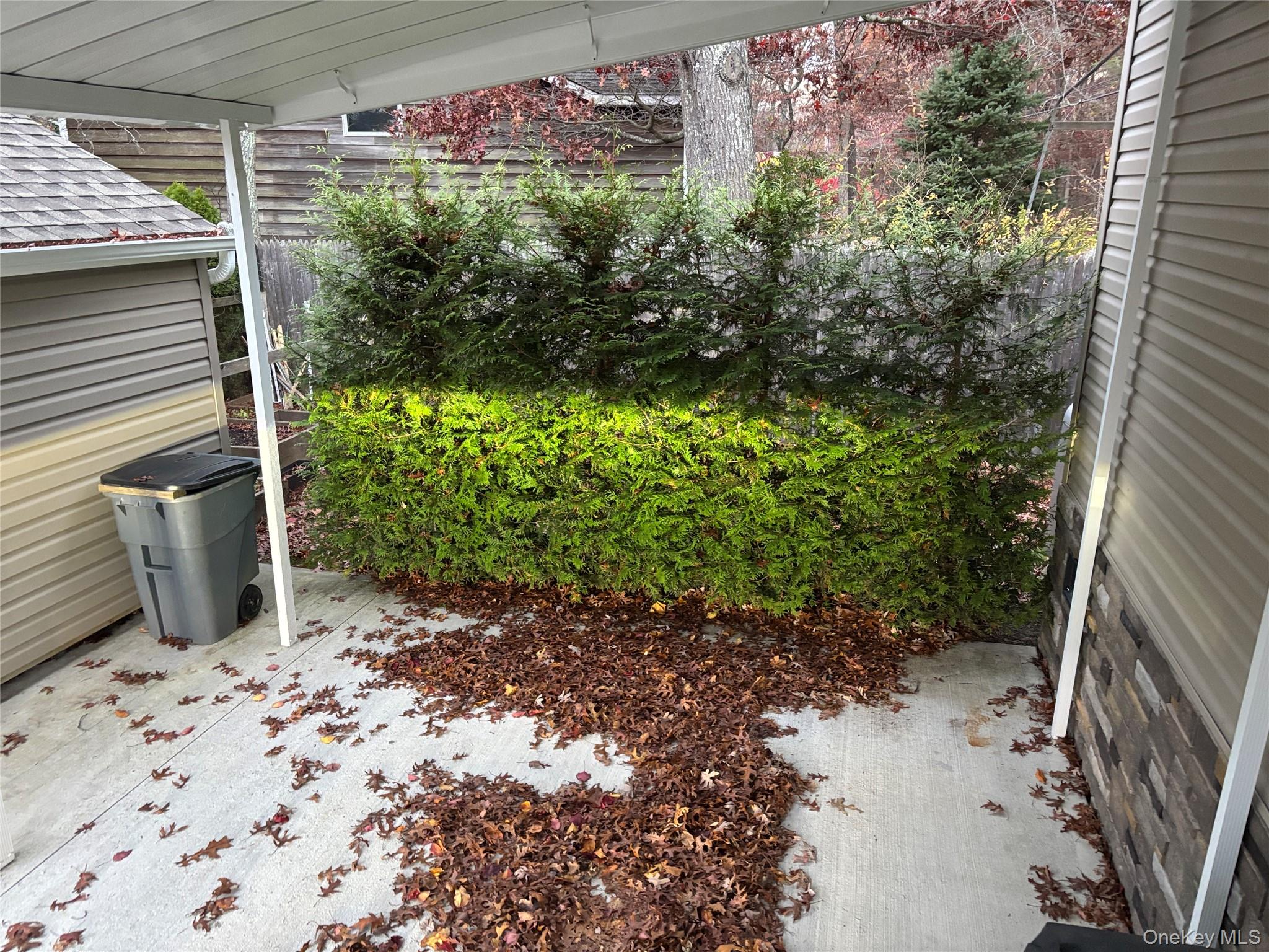 61 Forge Road, Unit 29 Riverhead, NY 11901 - Photo 30 of 38 a view of a backyard with potted plants