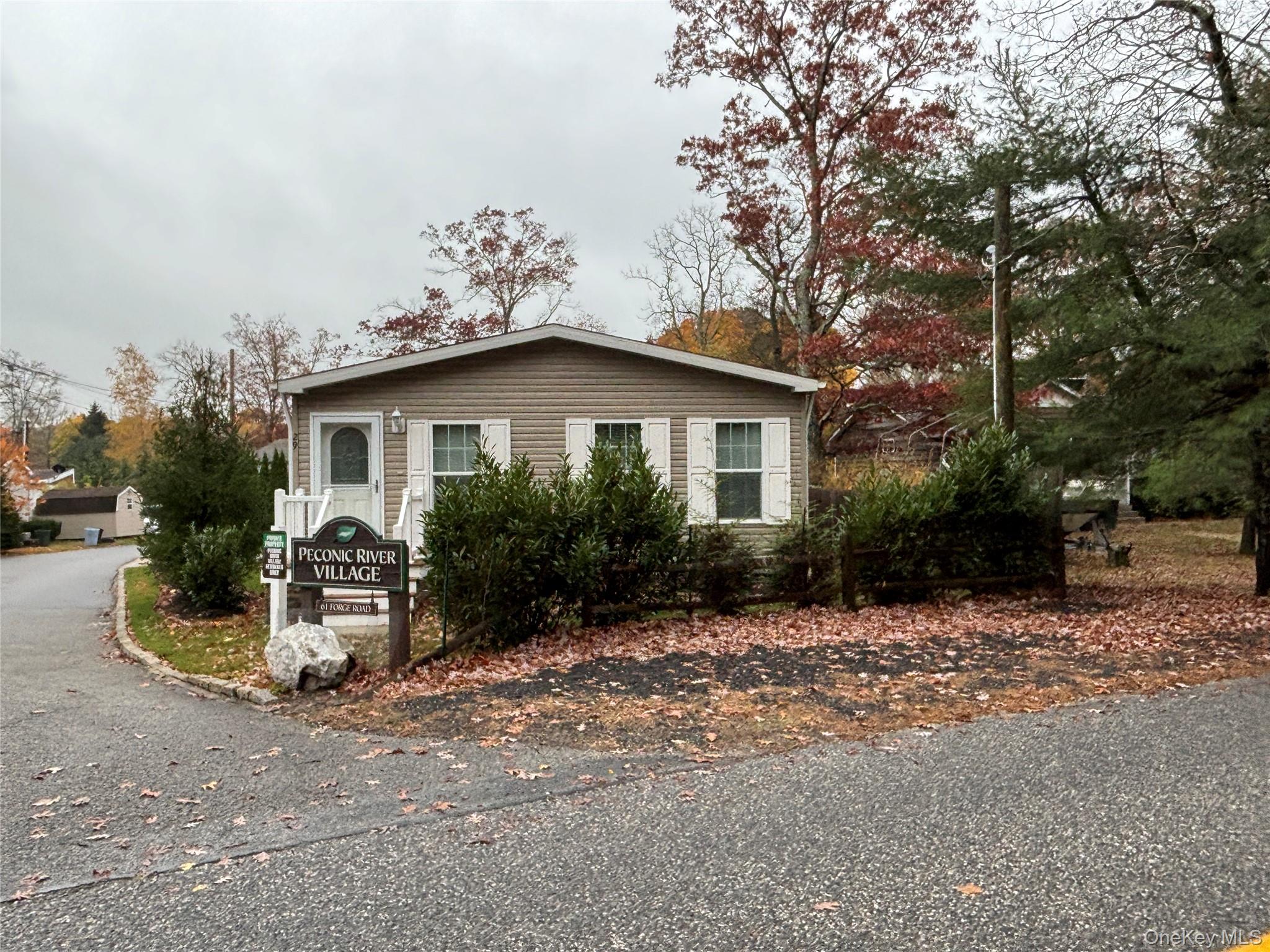 61 Forge Road, Unit 29 Riverhead, NY 11901 - Photo 38 of 38 a view of a house with a yard and hanging chair