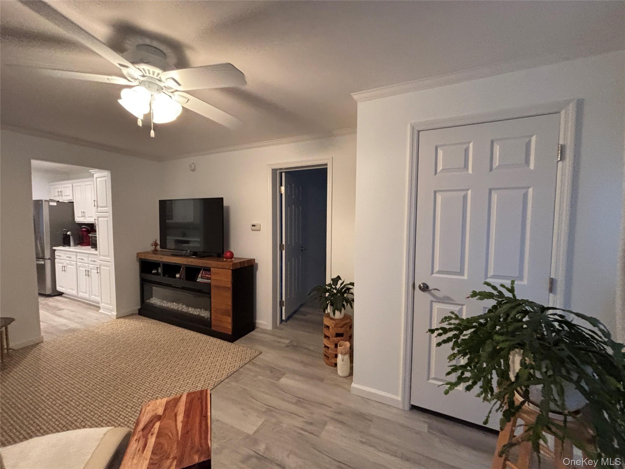 61 Forge Road, Unit 29 Riverhead, NY 11901 - Photo 5 of 38 a living room with furniture and a flat screen tv