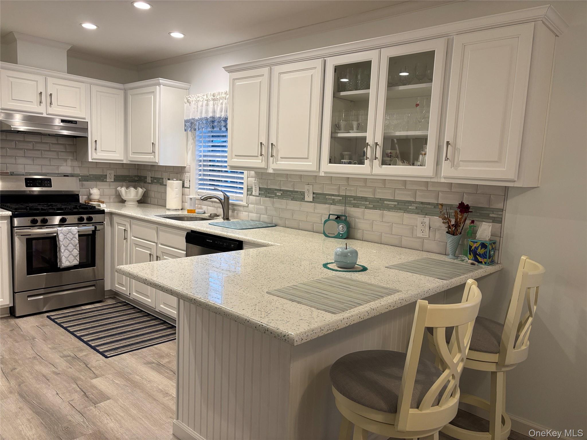 61 Forge Road, Unit 29 Riverhead, NY 11901 - Photo 9 of 38 a kitchen with a stove a sink and a refrigerator