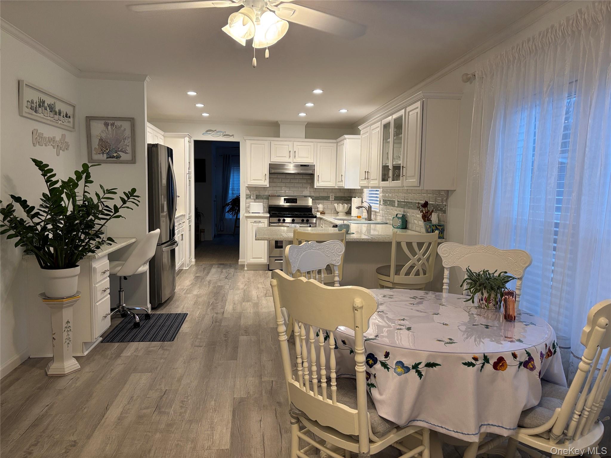 61 Forge Road, Unit 29 Riverhead, NY 11901 - Photo 10 of 38 a view of a dining room with furniture window and wooden floor