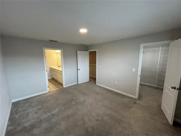 a view of an empty room and a window