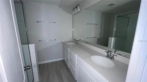a bathroom with a sink and mirror