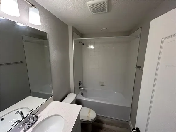 a bathroom with a sink a toilet and a bathtub