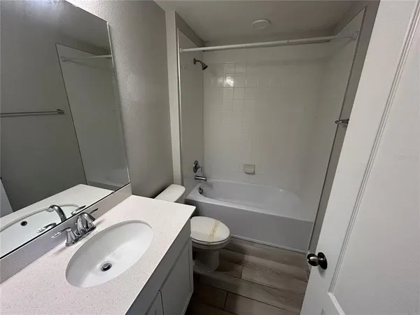a bathroom with a sink a toilet and a bathtub