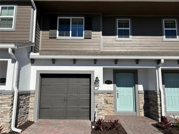 a front view of a house with garage