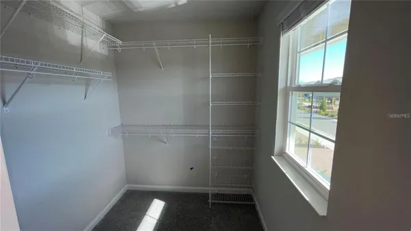 a view of walk in closet with window