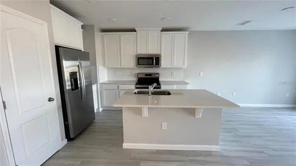 a white refrigerator freezer sitting inside of a kitchen