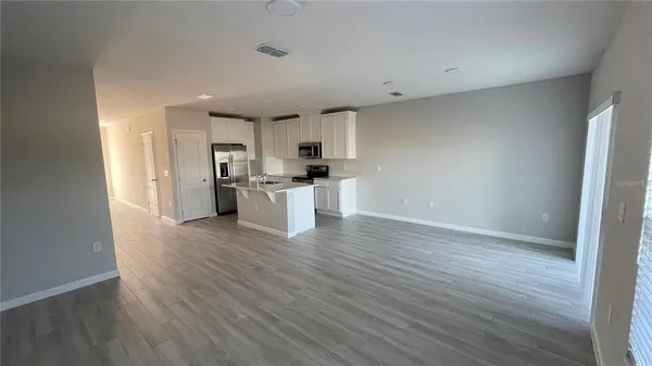 a view of a kitchen with a sink and a refrigerator