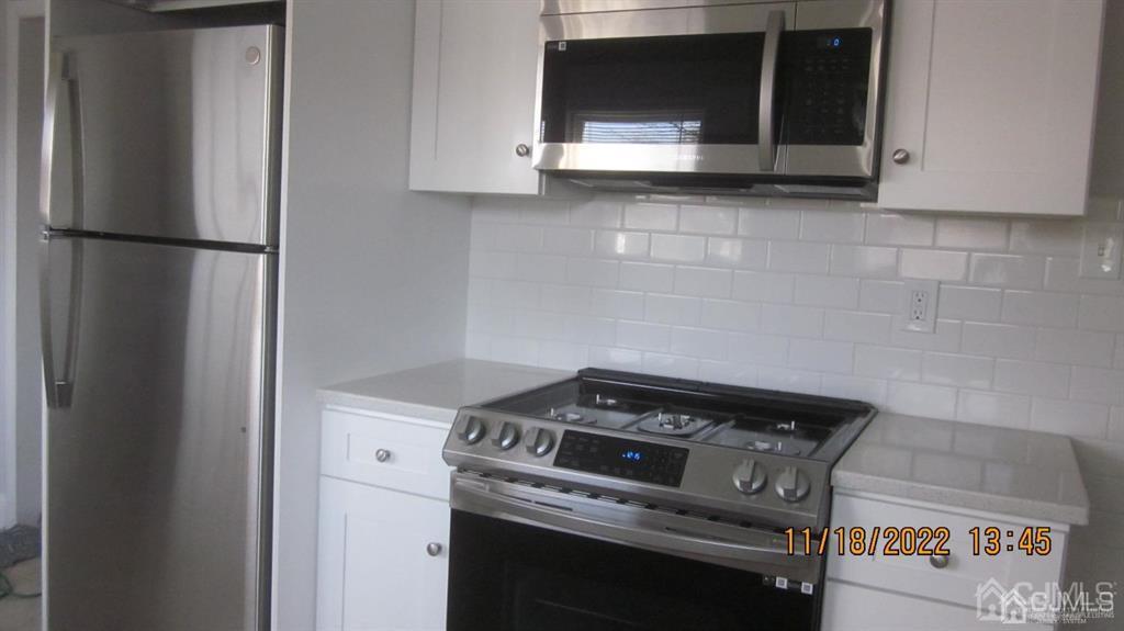 B Plainfield Road Edison, NJ 08820 - Photo 5 of 7 a kitchen with a stove and a microwave