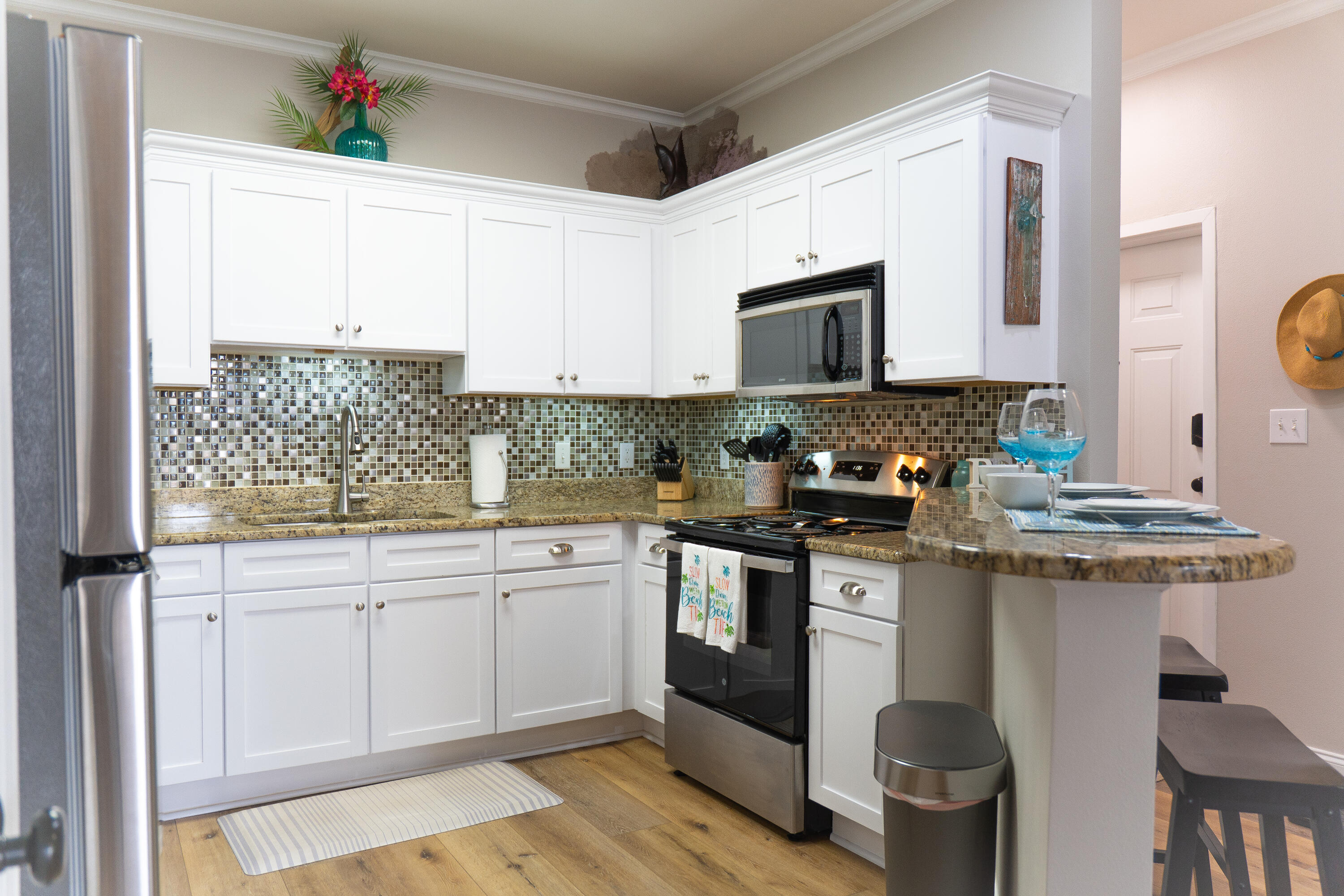 136 Shorebird Drive, Unit 724 Santa Rosa Beach, FL 32459 - Photo 12 of 49 a kitchen with stainless steel appliances granite countertop a stove a sink and a microwave